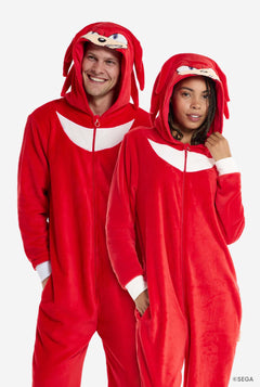 Two people wearing red Knuckles-themed onesies on a white background