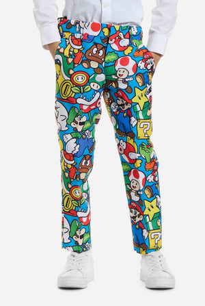 Image of kid wearing a Super Mario all over print suit, consisting of blazer, pants and tie. Main color is blue, but there is also yellow, red and white. View of the pants.