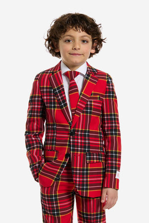 Child wearing a red plaid Christmas suit on a white background