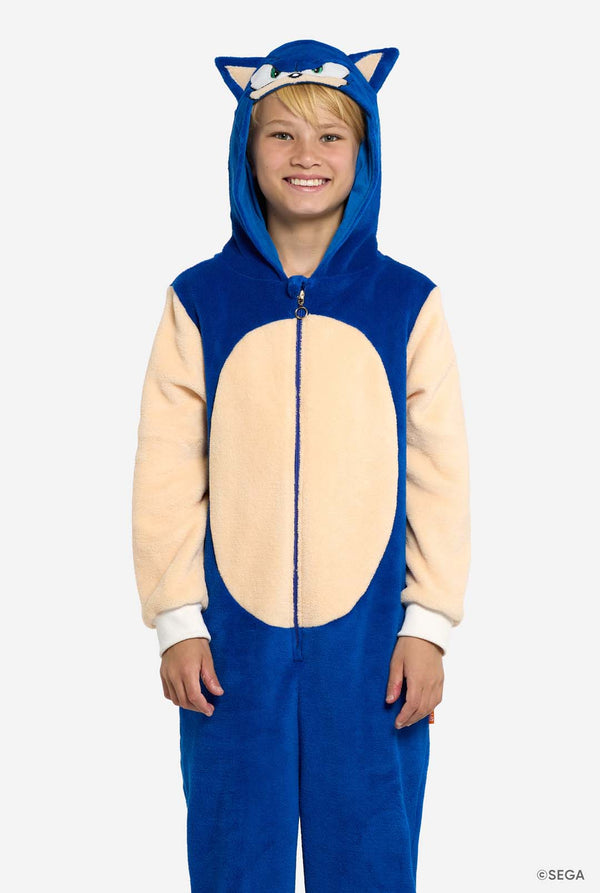 Child wearing a blue and beige Sonic onesie with a hood, resembling a character from SEGA.