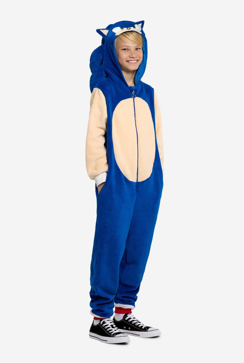 Child wearing a blue and beige Sonic onesie with a hood, resembling a character from SEGA.