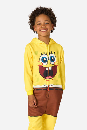 Child wearing a yellow SpongeBob onesie and pants on a white background