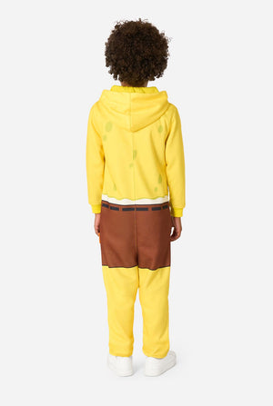 Person wearing a yellow onesie and brown pants on a white background. View from the back