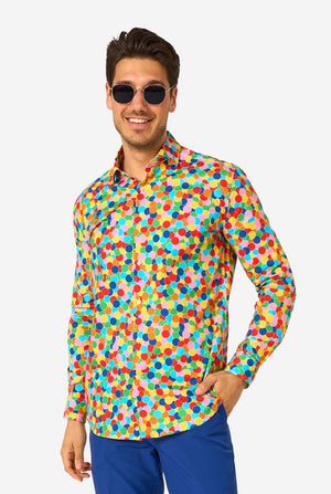 Man wearing a colorful polka dot confetti shirt and sunglasses on a white background