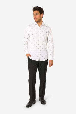 Man wearing a white Christmas tree patterned shirt and black pants on a white background