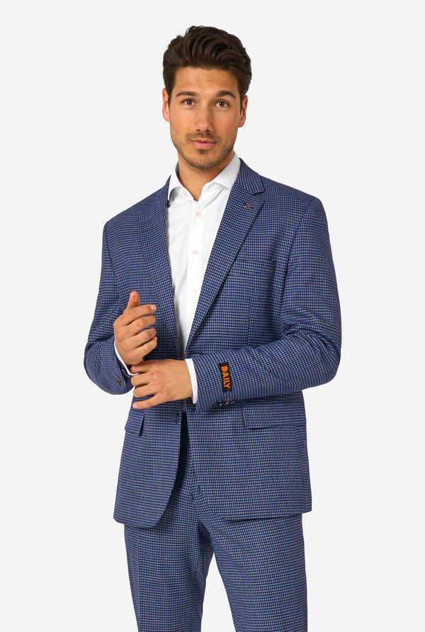 Man wearing a blue checkered suit with a white shirt on a white background