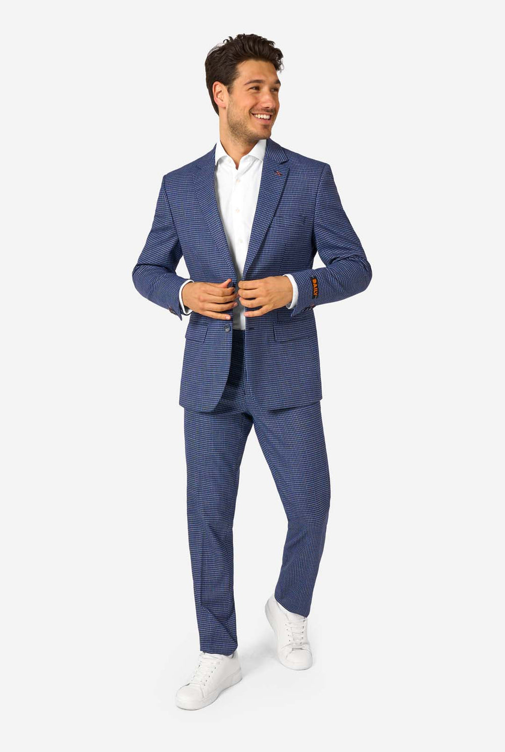 Man wearing a blue checkered suit with a white shirt on a white background