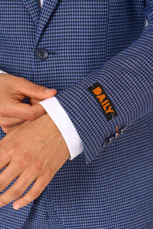Close-up of a blue checkered suit jacket with the DAILY label on a white background
