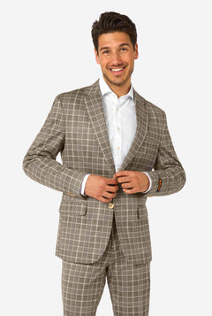 Man wearing a brown checkered suit with a white shirt on a white background