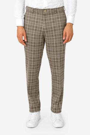 Person wearing brown checkered pants on a white background