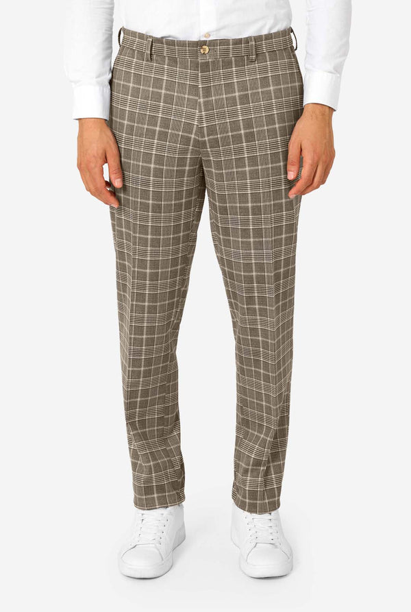 Person wearing brown checkered pants on a white background