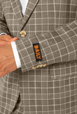 Close-up of a gray checkered suit with the DAILY label on the sleeve.