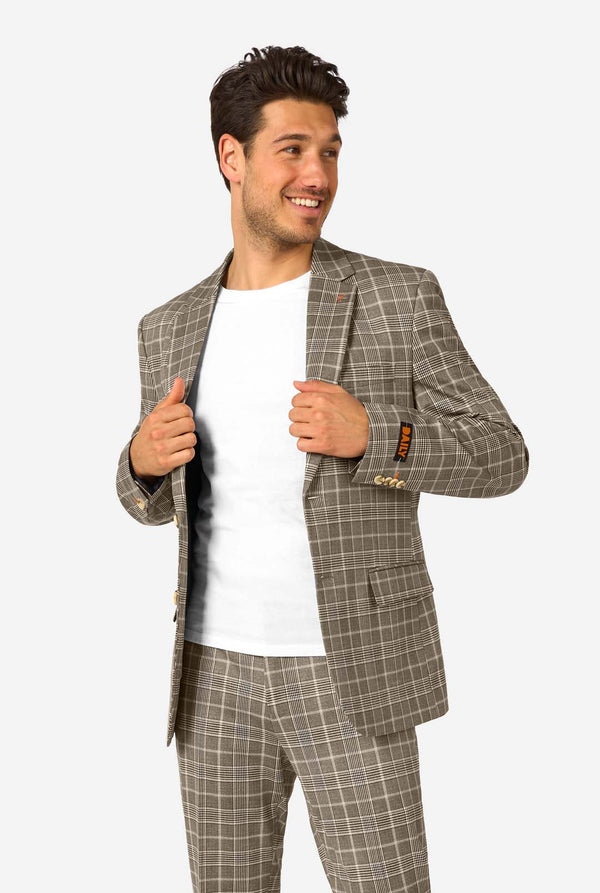 Man wearing a brown checkered suit with a white shirt on a white background