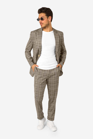 Man wearing a brown checkered suit with sunglasses on a white background