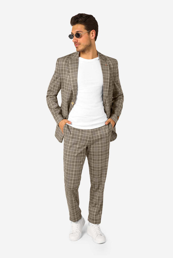 Man wearing a brown checkered suit with sunglasses on a white background
