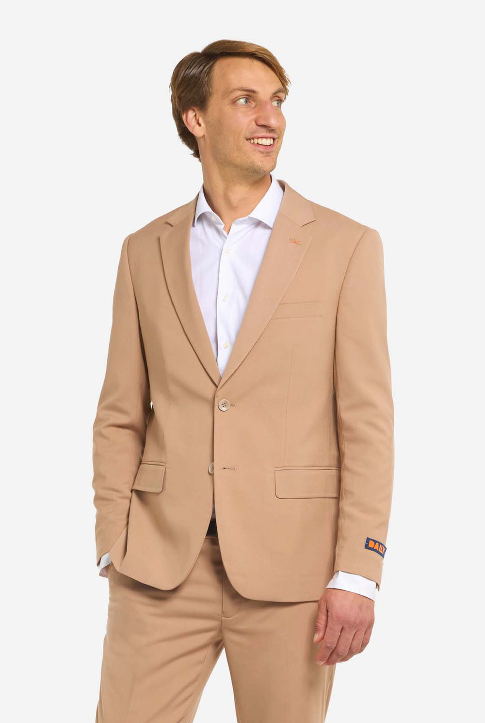 Man wearing a beige suit with a white shirt on a white background