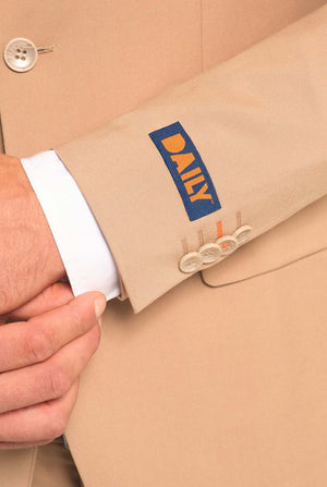 Close-up of a beige suit jacket with a 'DAILY' logo on the sleeve.
