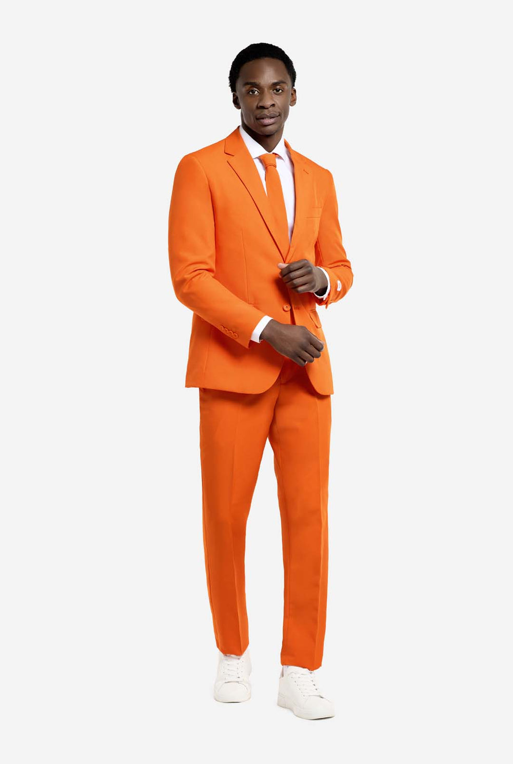 Man wearing an orange suit with a white shirt and tie on a plain background