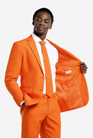 Man wearing an orange suit with a white shirt, holding the jacket open.