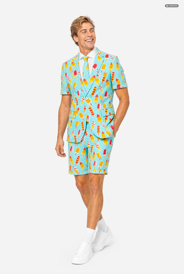 A man modeling a light blue three-piece suit with a colorful ice cream cone pattern, featuring a short-sleeve blazer, matching trousers, and a matching tie, set against a plain light gray background. Full body image.