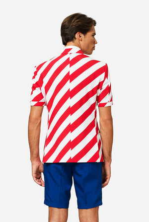 Man wearing a red, white-striped blazer and blue shorts. Resembling an American flag pattern on a plain background. View from the back.