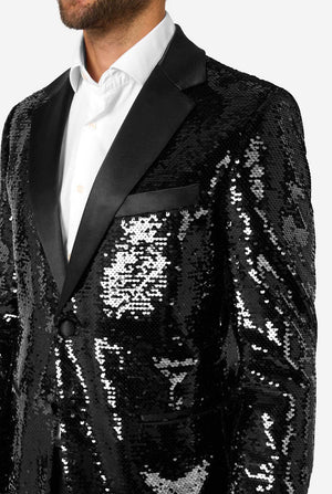 Black sequin tuxedo jacket worn by a person on a white background