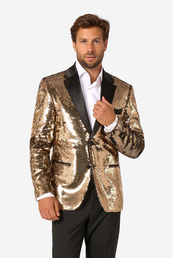 Man wearing a gold sequin jacket with black lapels on a white background