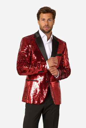 Man wearing a red sequin jacket with black lapels on a white background