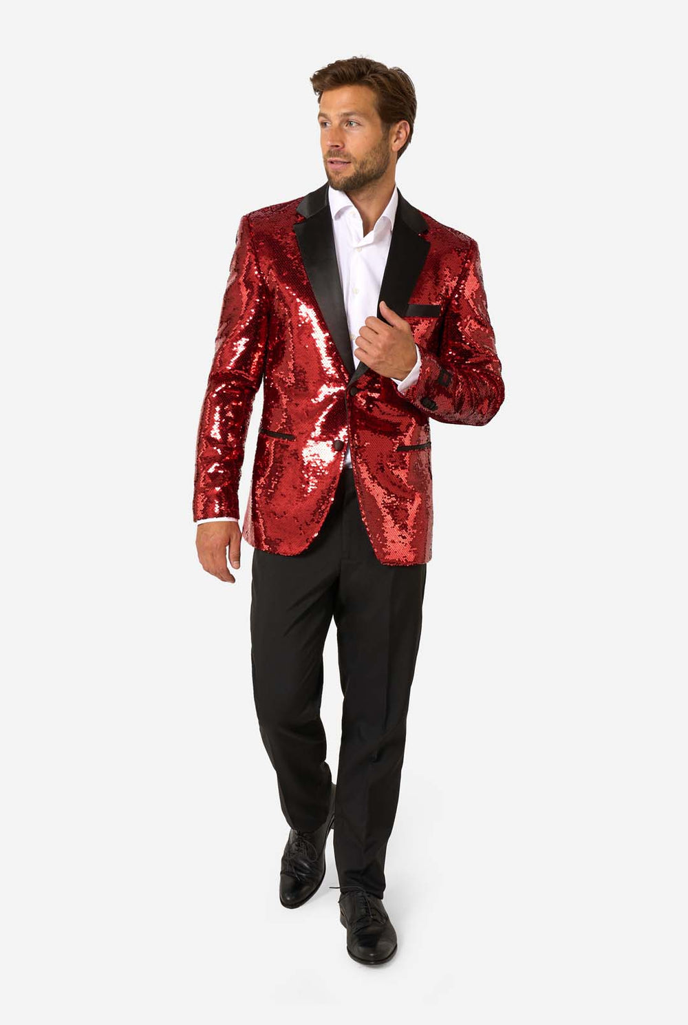 Man wearing a red sequin jacket with a white shirt and black pants on a white background.