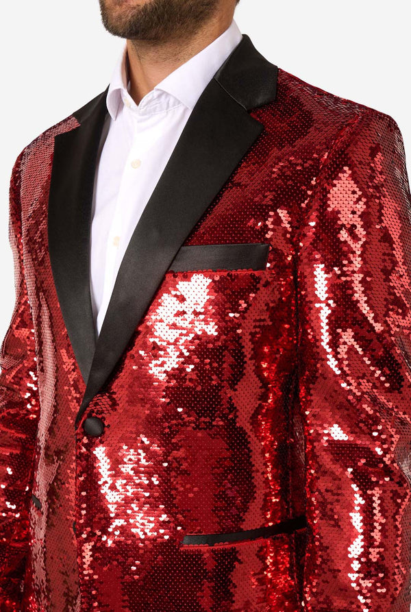 Red sequin jacket with black lapels worn by a person on a white background