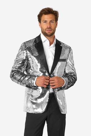 Man wearing a silver sequin jacket with black lapels on a white background