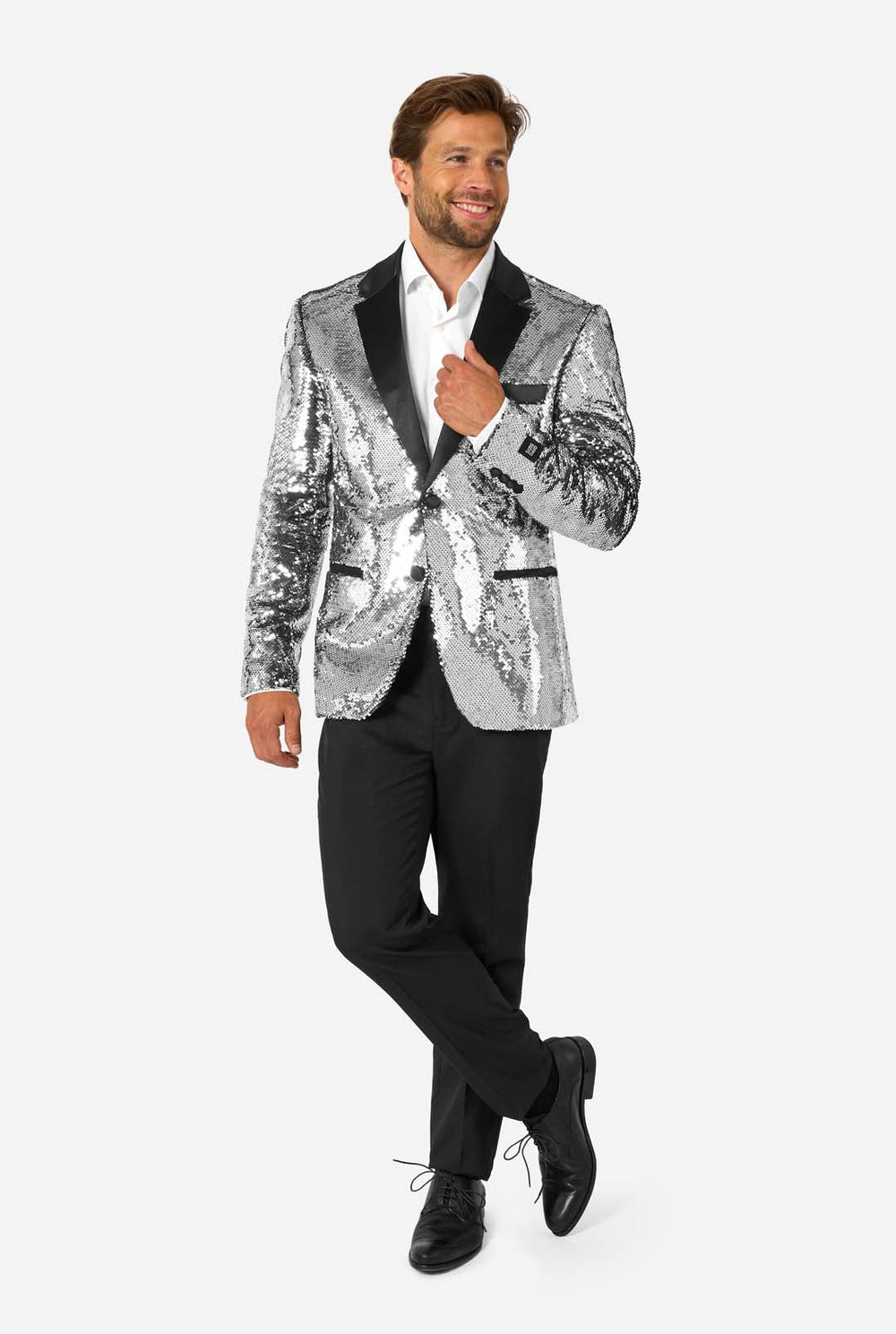 Man wearing a silver sequin jacket with black lapels on a white background