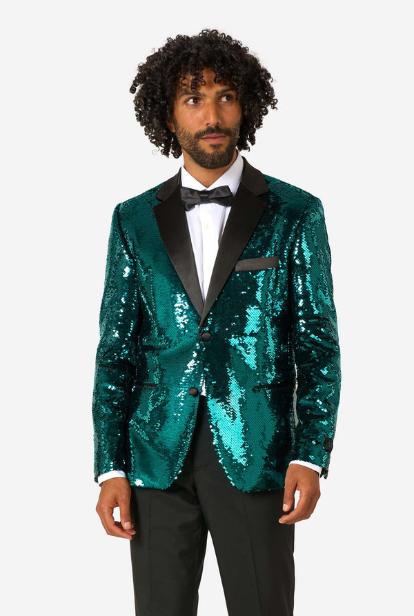 Man wearing a teal sequin tuxedo jacket on a white background