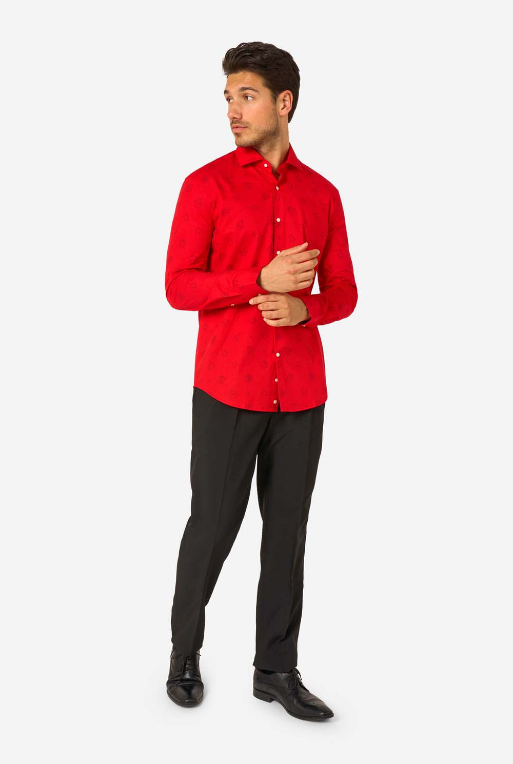 Man wearing red dress shirt with black outlined Christmas icons and black pants.