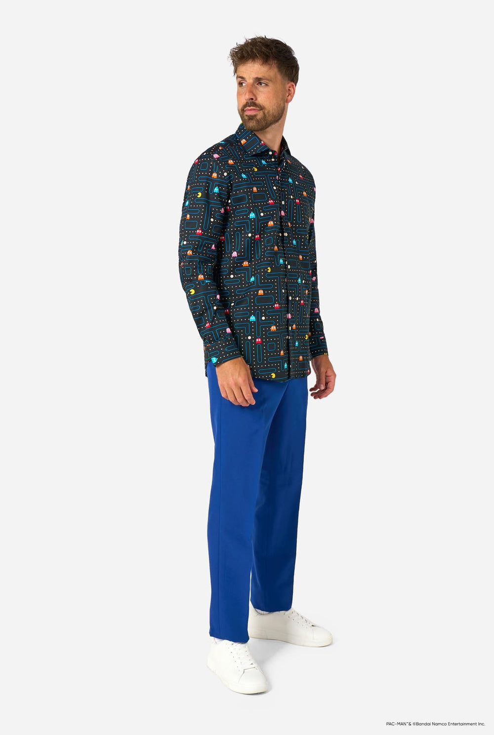Image of a man wearing a black shirt with Pac-Man print and a blue pants. 