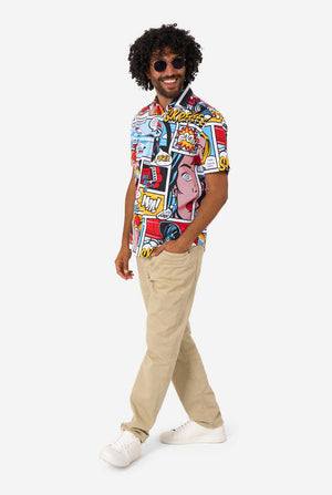 Man wearing a colorful patterned shirt and beige pants on a white background