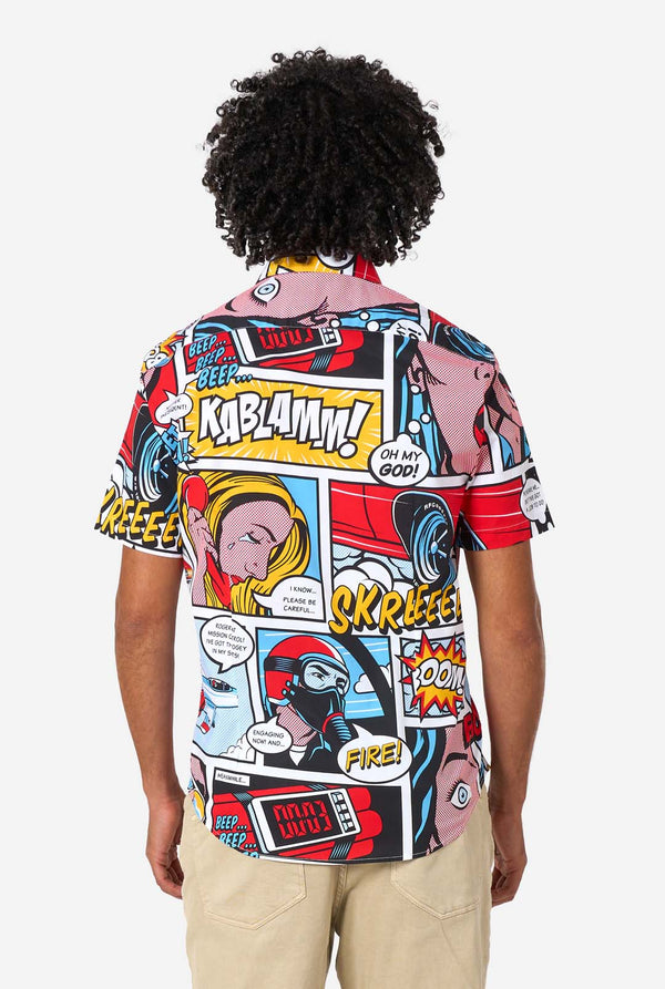 Person wearing a colorful comic book-themed shirt with various graphics and text.