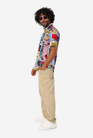 Man wearing a colorful patterned shirt and beige pants on a white background, side view