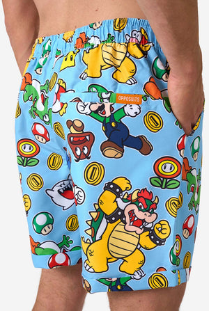 Colorful Mario-themed shorts with characters and graphics on a blue background.