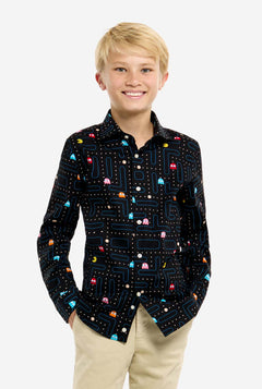 Young boy wearing a black shirt with colorful Pac-Man pattern on a white background