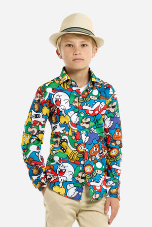 Image of teen wearing a Super Mario all over print shirt. Main color is blue, but there is also yellow, red and white. Kid also wearing a beige hat,