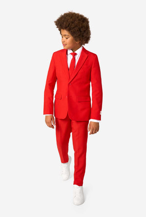 Person wearing a red suit with a white shirt and white shoes on a white background