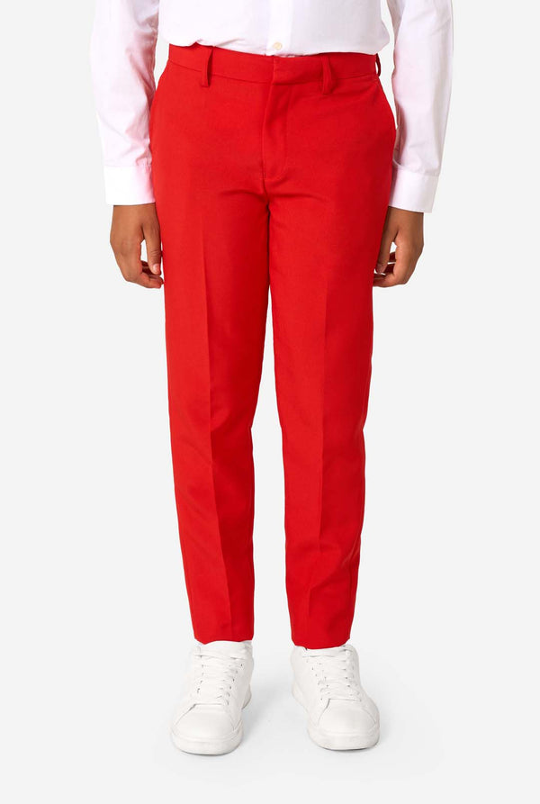 Person wearing red pants and white shoes on a white background