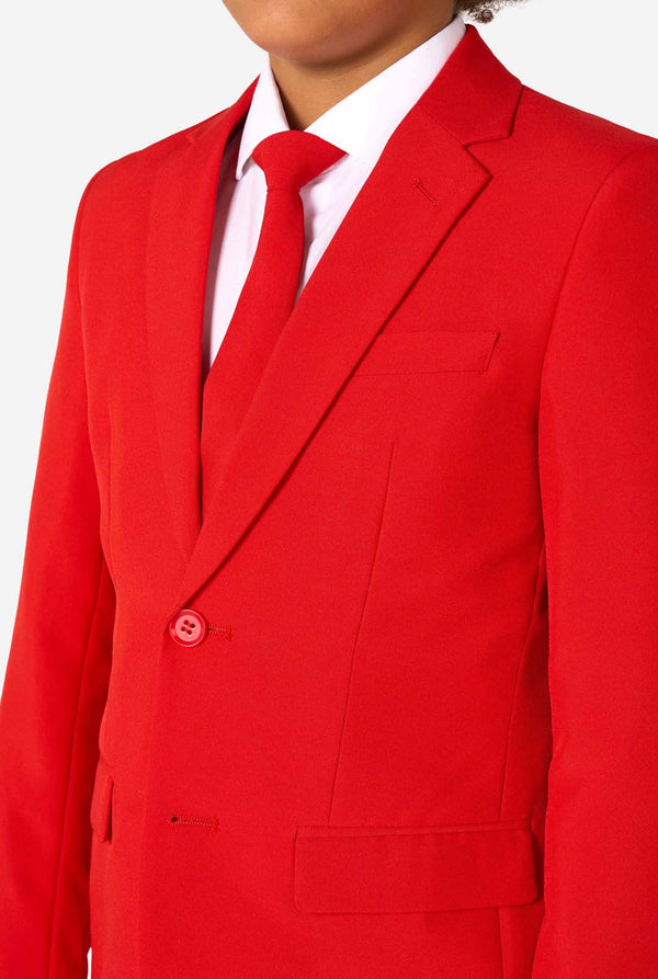 Red suit jacket with a white shirt and red tie on a white background, close-up.