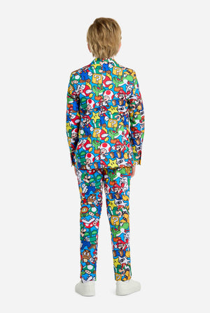 Image of teen wearing a Super Mario all over print shirt, consisting of blazer, pants and tie. Main color is blue, but there is also yellow, red and white. View from the back.