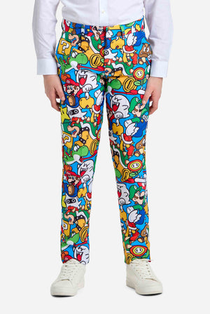 Image of teen wearing a Super Mario all over print shirt, consisting of blazer, pants and tie. Main color is blue, but there is also yellow, red and white. Pants close up.