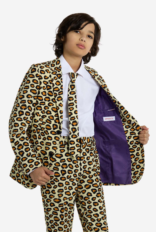 Child wearing a leopard print suit with a purple pocket square on a white background