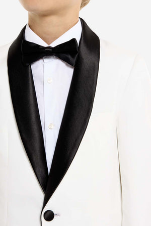 White tuxedo with black lapels and bow tie on a white background. Chest close-up.