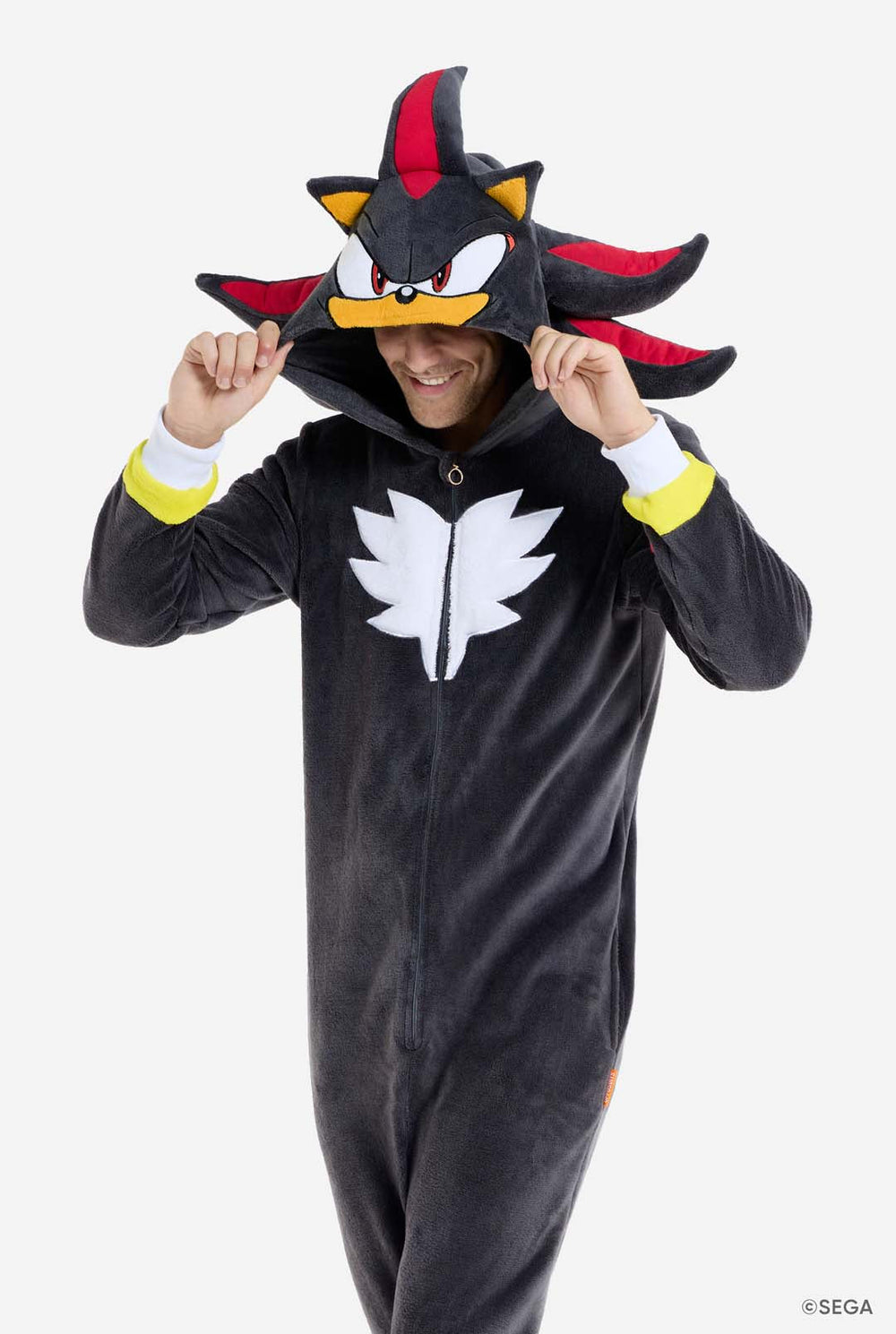 Person wearing a black Shadow onesie with a sonic character design on a white background