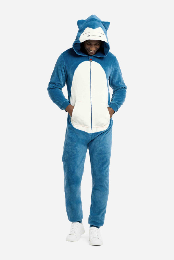 Person wearing a blue and white Snorlax onesie with cat ears on a white background